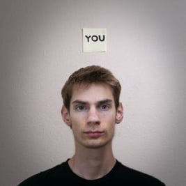 Portrait of a young male labelled as YOU.