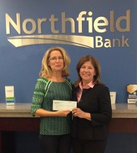 Diane Senerchia, Executive Director for Northfield Bank Foundation presents grant check to Anne DeMarzo, SMART volunteer.